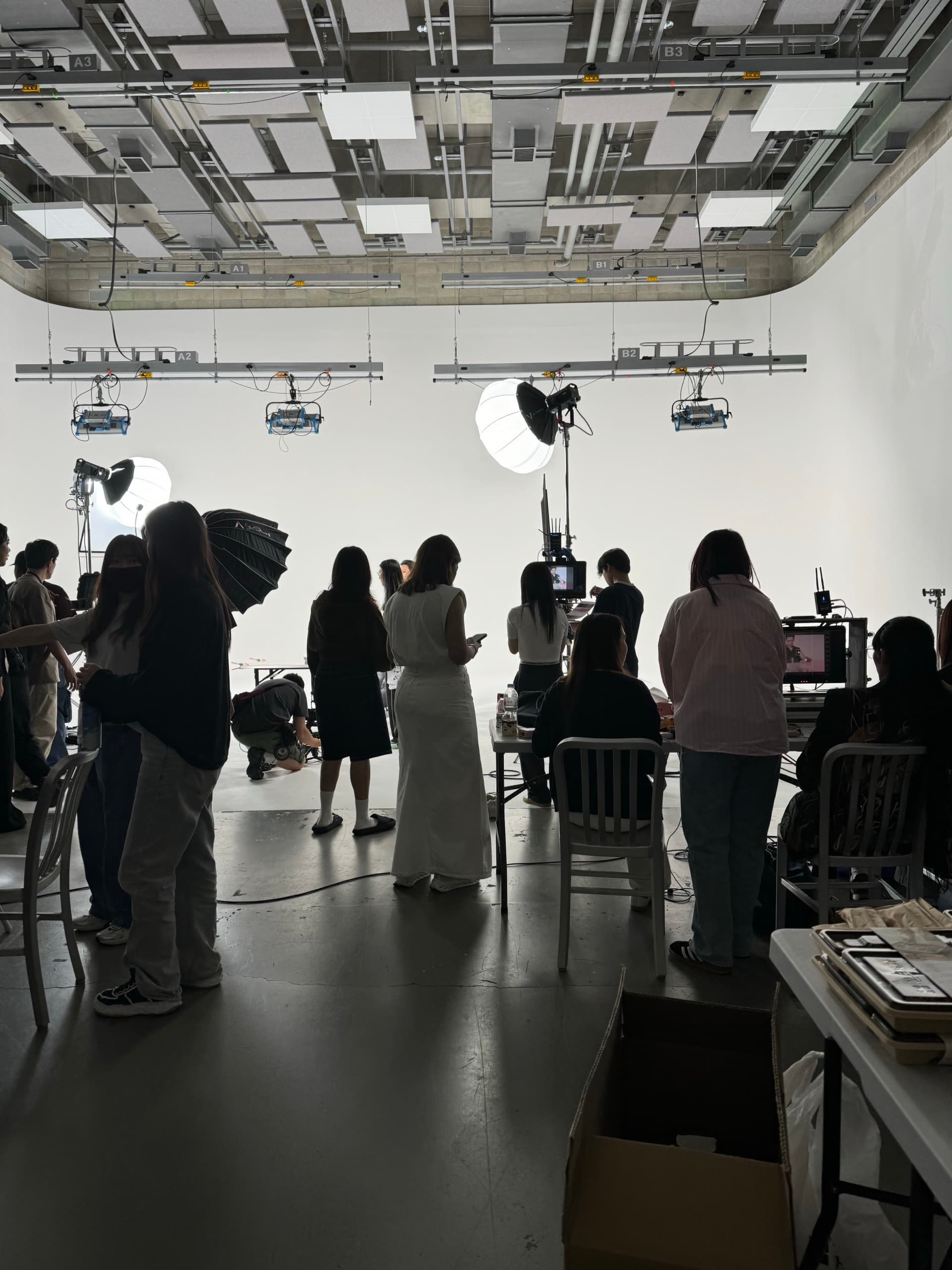 GripDude crew shooting in a white studio under lantern lights